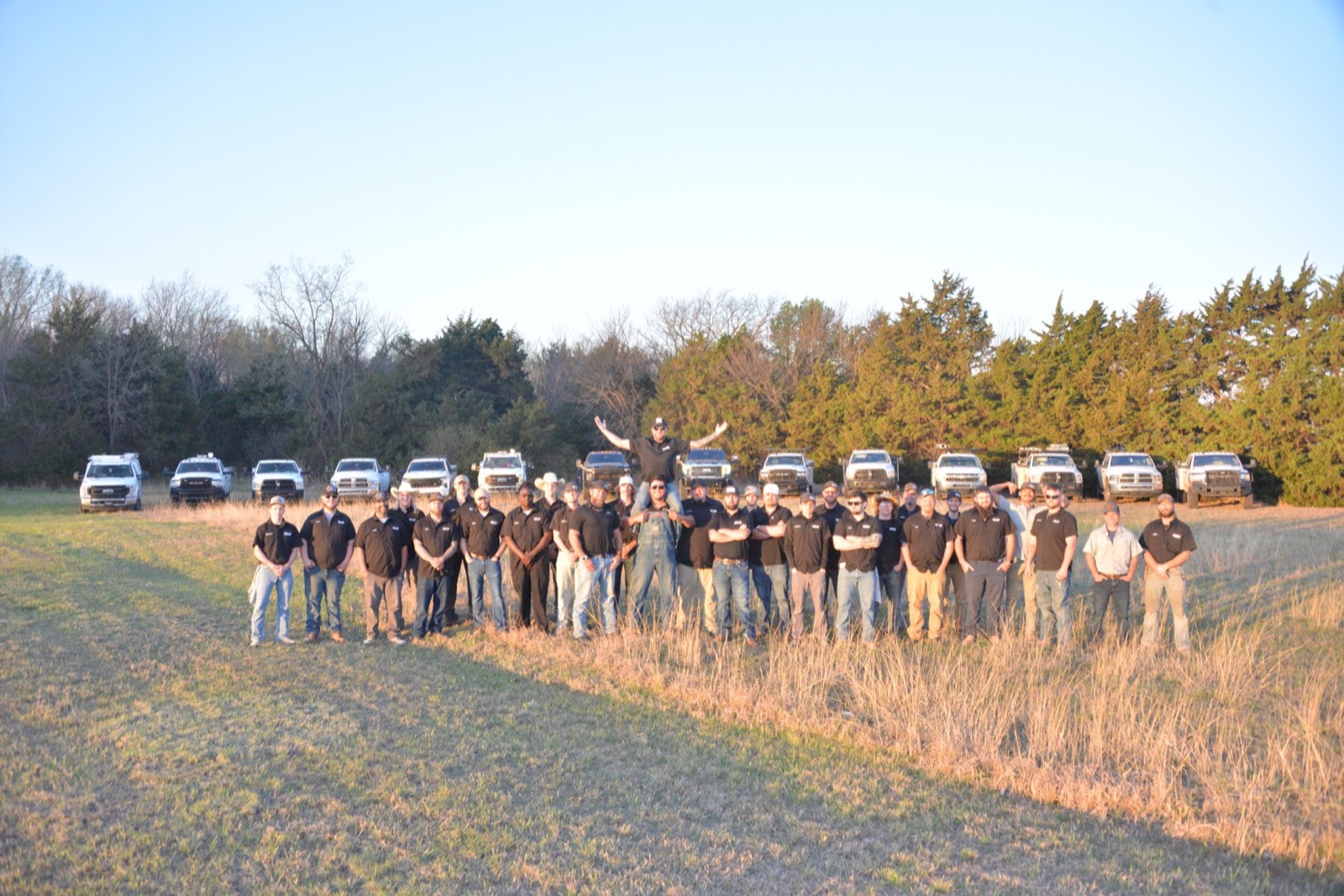 The Okie Plumbing & Utilities crew lined up in front of their truck fleet